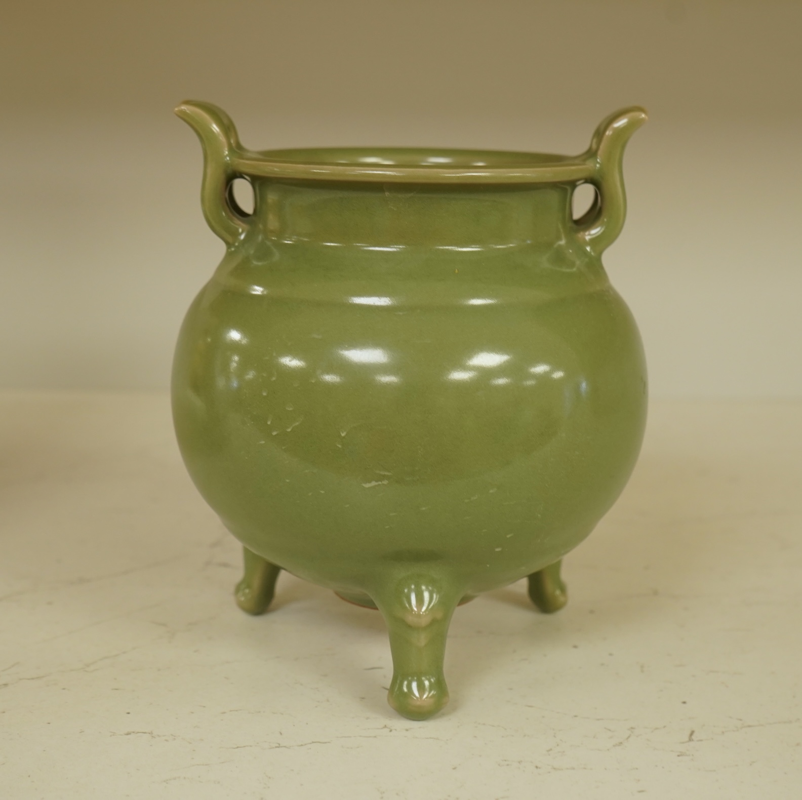 A Chinese green glazed censor on tripod feet, 16cm high
